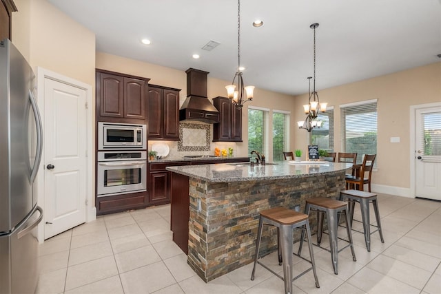 kitchen featuring custom range hood, a sink, appliances with stainless steel finishes, and light tile patterned flooring