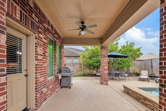 view of patio / terrace with a fenced backyard, a ceiling fan, a hot tub, outdoor dining area, and area for grilling