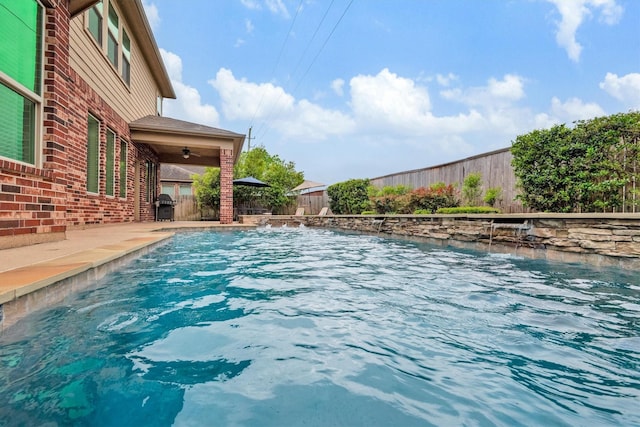 view of pool featuring a grill, a fenced backyard, a ceiling fan, and a fenced in pool
