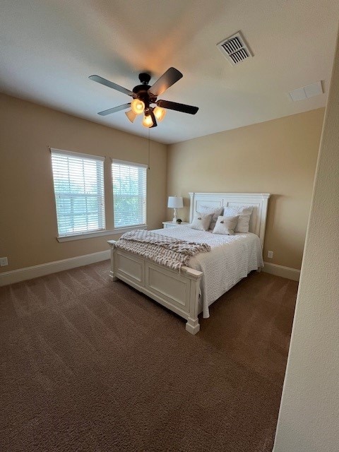 12919 Arlington Meadows Ln, Tomball, TX 77377 - bedroom with dark colored carpet, baseboards, and ceiling fan