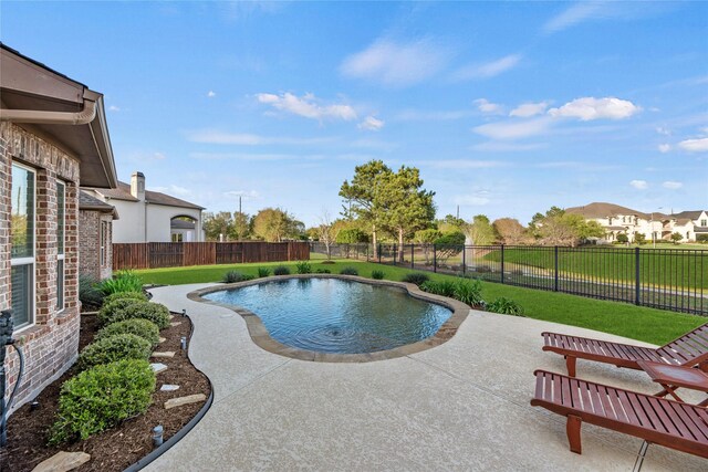 view of swimming pool with a patio area, a fenced backyard, a fenced in pool, and a yard