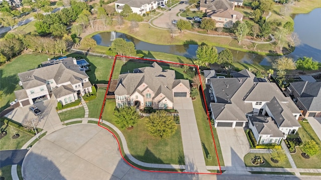 drone / aerial view featuring a residential view and a water view
