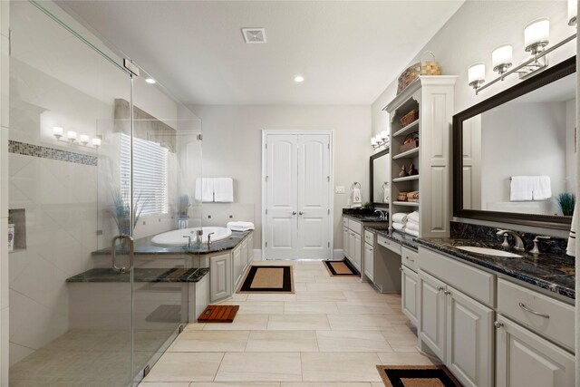 bathroom featuring a shower stall, a garden tub, vanity, visible vents, and recessed lighting