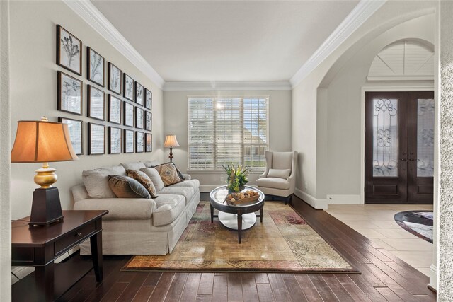 interior space featuring ornamental molding, french doors, wood-type flooring, arched walkways, and baseboards