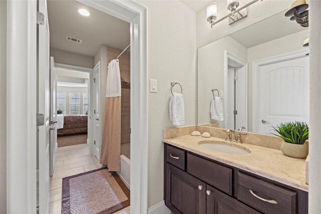 full bathroom with shower / bath combo, visible vents, tile patterned flooring, and vanity
