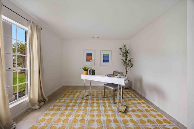 office space featuring baseboards and visible vents