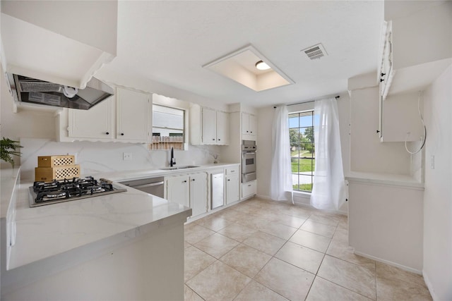 kitchen with white cabinets, visible vents, light tile patterned floors, baseboards, and appliances with stainless steel finishes