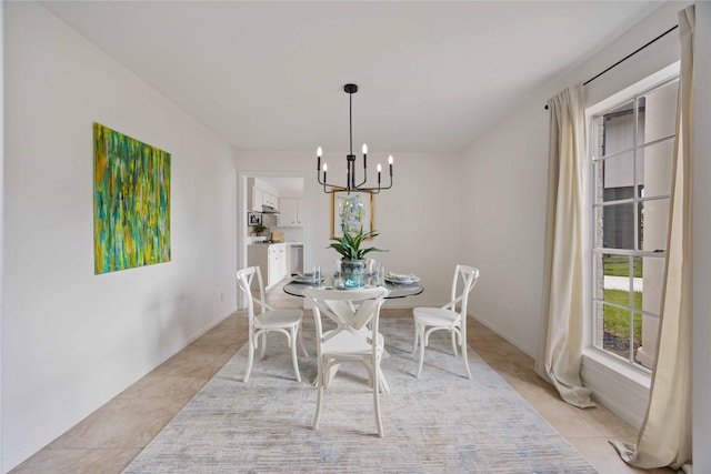 dining room featuring an inviting chandelier and light tile patterned floors