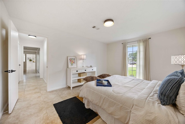 bedroom with baseboards, visible vents, and light tile patterned floors