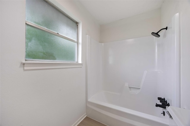 bathroom with baseboards and bathtub / shower combination