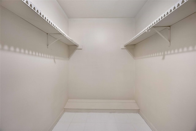 spacious closet with tile patterned floors