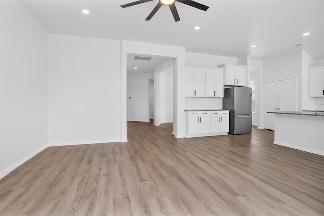 31411 Raleigh Creek Dr, Tomball, TX 77375 - unfurnished living room with a ceiling fan, light wood-style floors, baseboards, and recessed lighting
