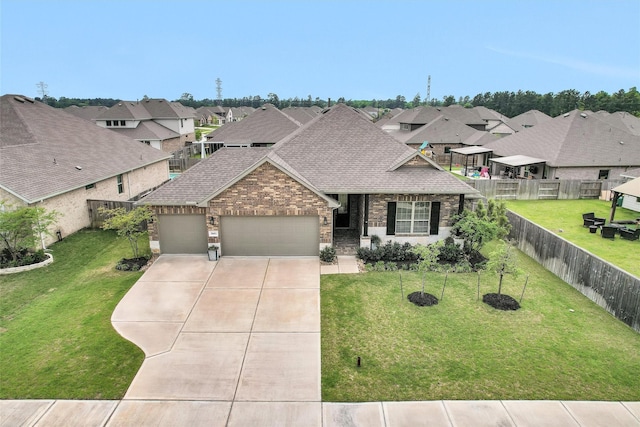 31411 Raleigh Creek Dr, Tomball, TX 77375 - view of front of property with roof with shingles, an attached garage, driveway, a residential view, and brick siding