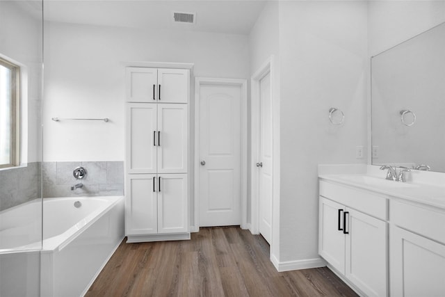 31411 Raleigh Creek Dr, Tomball, TX 77375 - bathroom featuring a bath, vanity, wood finished floors, and baseboards