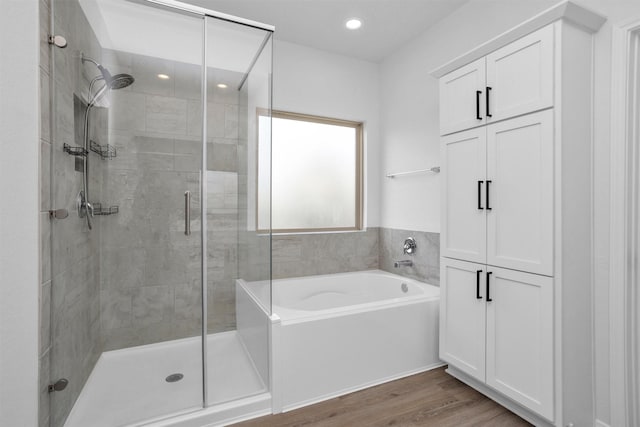31411 Raleigh Creek Dr, Tomball, TX 77375 - full bathroom with a stall shower, a garden tub, wood finished floors, and recessed lighting