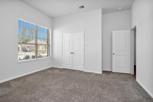 31411 Raleigh Creek Dr, Tomball, TX 77375 - unfurnished bedroom with dark colored carpet, baseboards, and a closet
