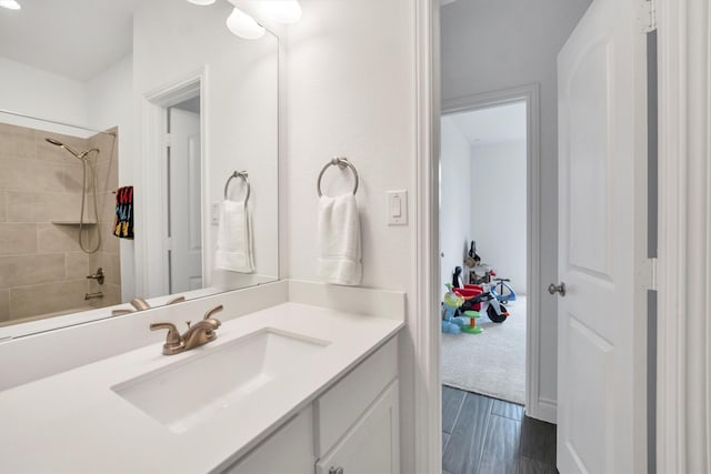 full bathroom featuring wood finished floors and vanity