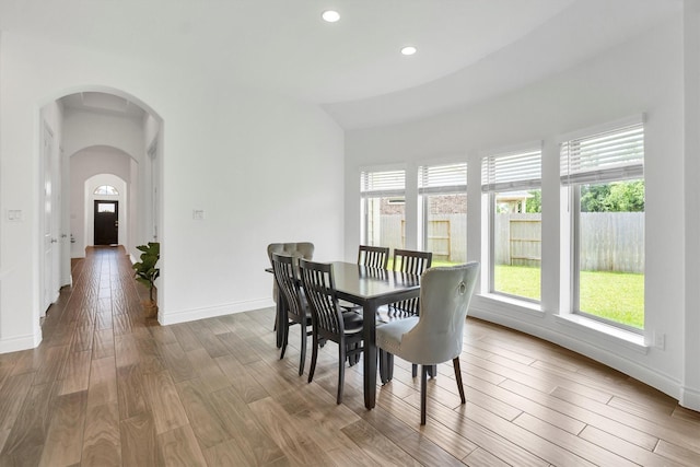 20131 Wild Horse Hollow Ln, Tomball, TX 77377 - dining room featuring healthy amount of natural light, wood finished floors, arched walkways, and recessed lighting