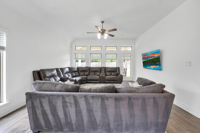 living room featuring baseboards, wood finished floors, and a ceiling fan