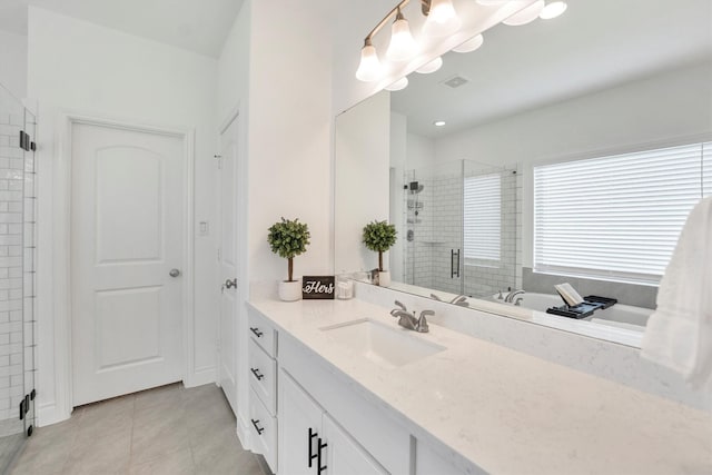 bathroom with tile patterned floors, vanity, a shower stall, and visible vents