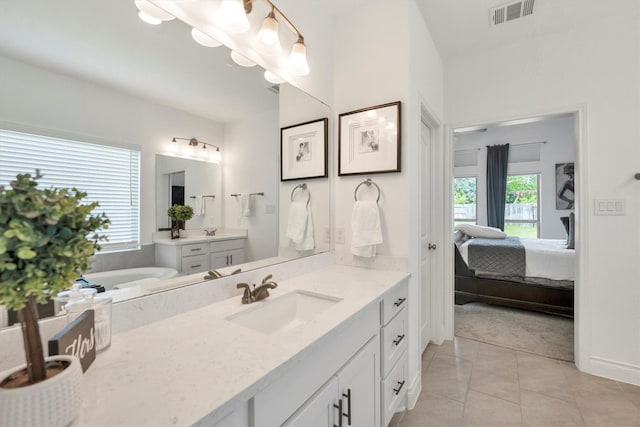 full bathroom with a sink, visible vents, ensuite bathroom, two vanities, and tile patterned floors