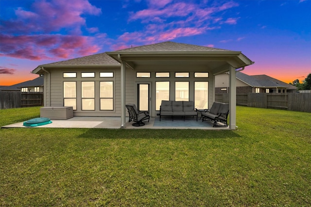 back of property featuring a yard, an outdoor hangout area, a patio, and a fenced backyard