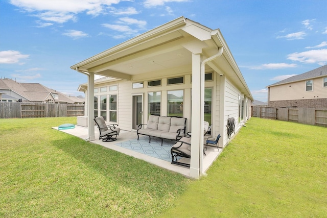 back of house with a patio area, a yard, and a fenced backyard