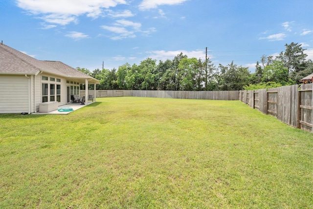 view of yard with a fenced backyard and a patio area