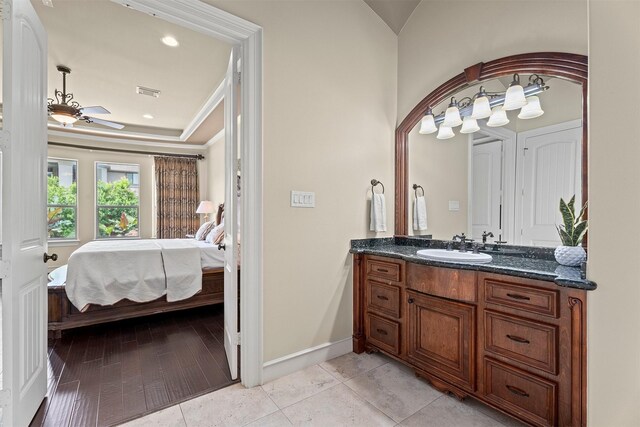 bathroom featuring ceiling fan, vanity, ensuite bath, baseboards, and visible vents
