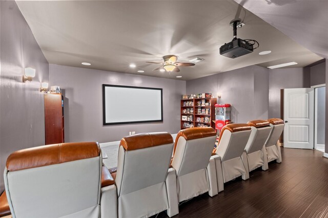 home theater room with a ceiling fan, visible vents, baseboards, dark wood-style floors, and recessed lighting
