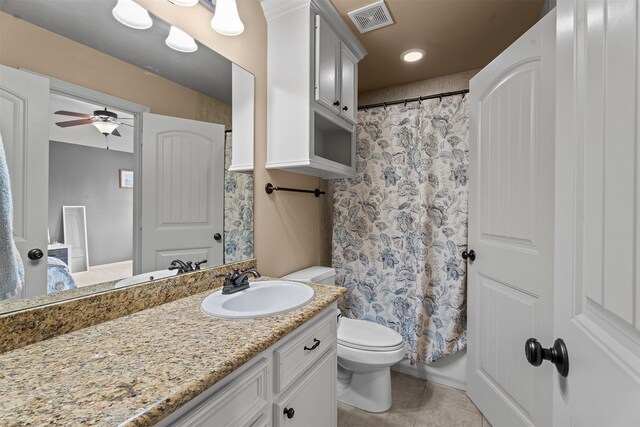 bathroom with vanity, toilet, a ceiling fan, a shower with curtain, and visible vents