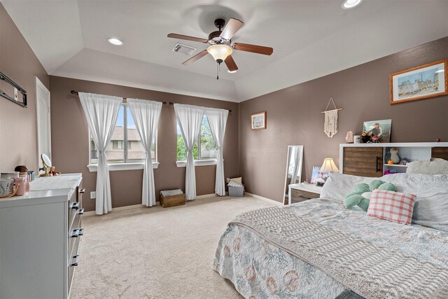 bedroom with light carpet, a tray ceiling, recessed lighting, and visible vents