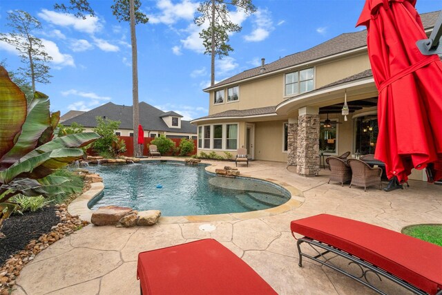pool featuring a patio, ceiling fan, and fence