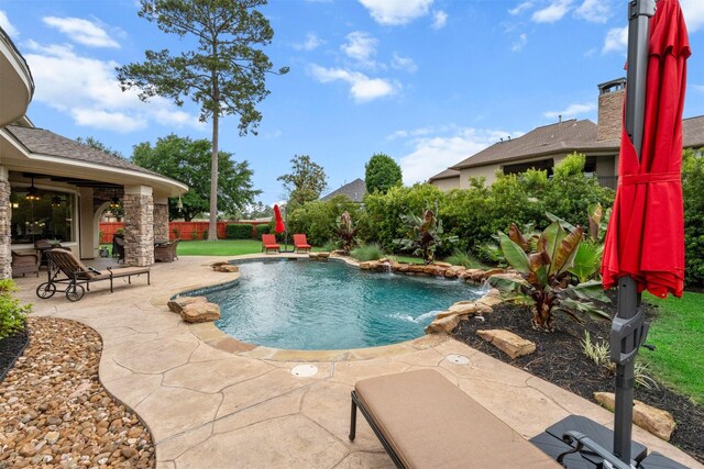 pool featuring a ceiling fan and a patio area