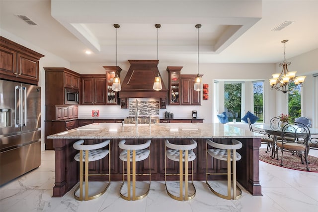 kitchen with marble finish floor, a raised ceiling, visible vents, and appliances with stainless steel finishes