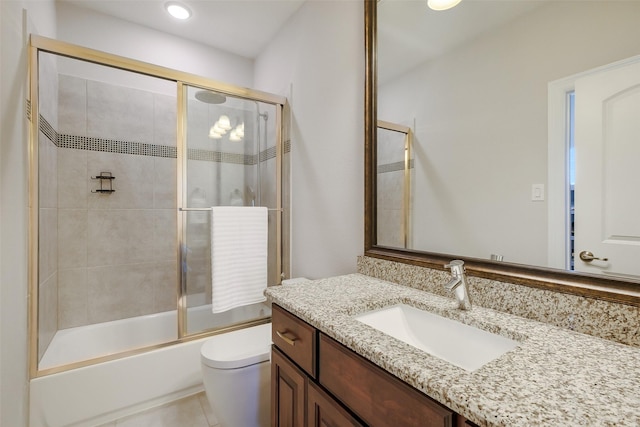 bathroom featuring recessed lighting, tile patterned floors, toilet, vanity, and bath / shower combo with glass door