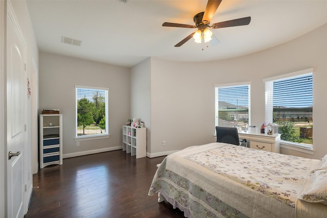bedroom featuring baseboards, visible vents, a ceiling fan, and dark wood-style floors