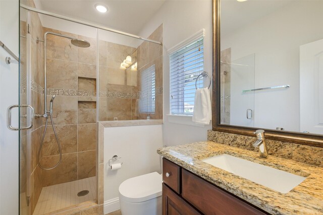 bathroom with vanity, recessed lighting, a shower stall, and toilet