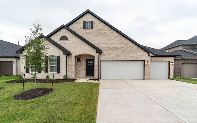331 Riesling Dr, Alvin, TX 77511 - french country home with driveway, an attached garage, brick siding, and a front yard