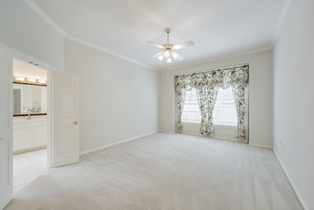 unfurnished room featuring baseboards, crown molding, light colored carpet, and ceiling fan