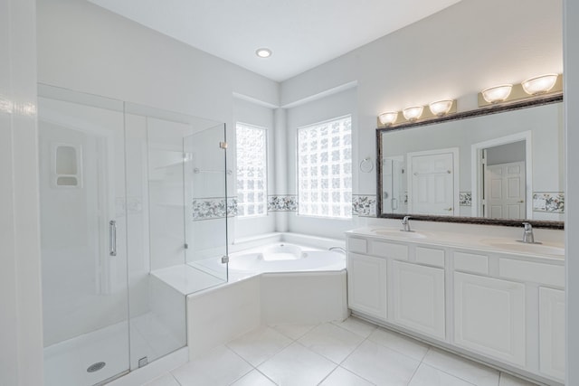 full bathroom with a bath, a shower stall, and a sink