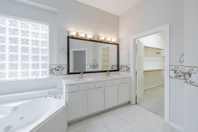 full bath featuring a healthy amount of sunlight, a sink, and tile patterned floors