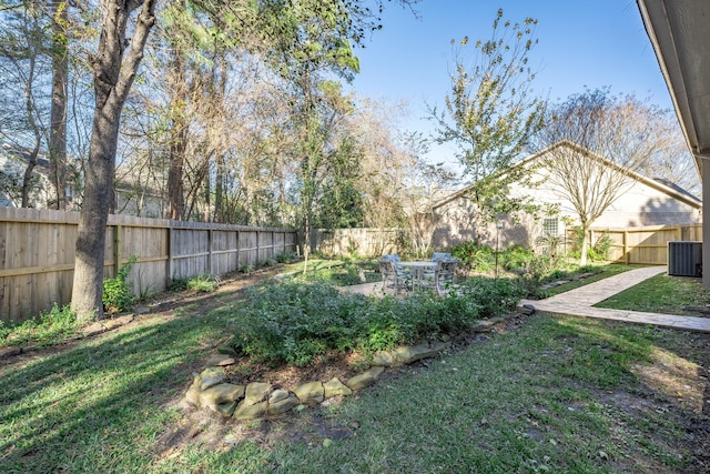 view of yard with a fenced backyard, central air condition unit, and a patio