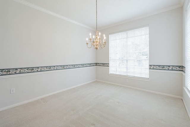 unfurnished room with light colored carpet, an inviting chandelier, ornamental molding, and baseboards