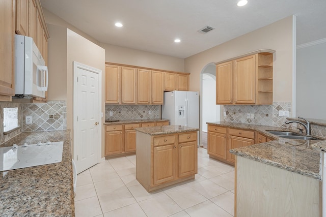 kitchen featuring open shelves, white appliances, a sink, and backsplash