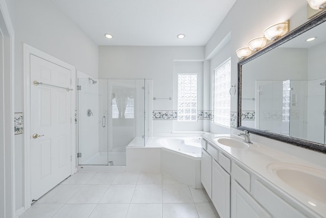 bathroom with a bath, a stall shower, and a sink