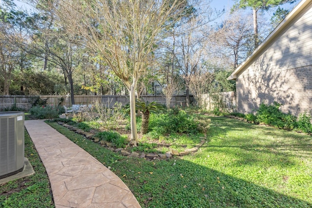 view of yard featuring a fenced backyard and central AC unit