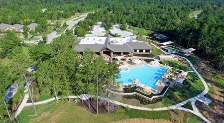 209 W Stargazer Lily Bnd, Montgomery, TX 77316 - aerial view of property's location with a heavily wooded area and a pool area