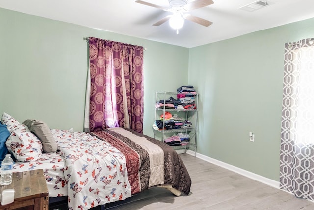 4506 Boicewood St, Houston, TX 77016 - bedroom featuring light wood-type flooring, baseboards, visible vents, and ceiling fan