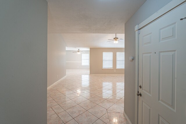 12626 Lacey Crest Dr, Houston, TX 77070 - empty room featuring light tile patterned floors, baseboards, and ceiling fan